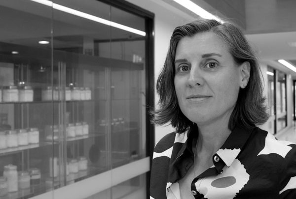 Tiffany Walsh beside glass window containing chemicals