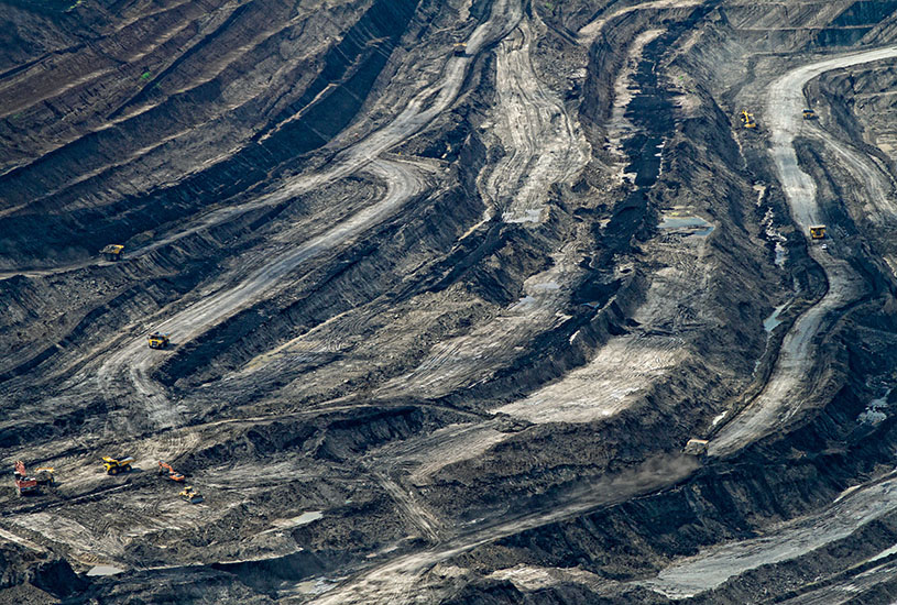 coal mining area with large vehicles traveling across