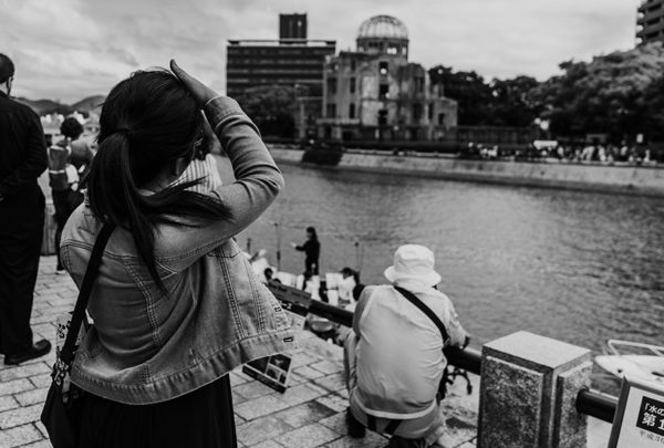 black and white woman looking at a building across the river