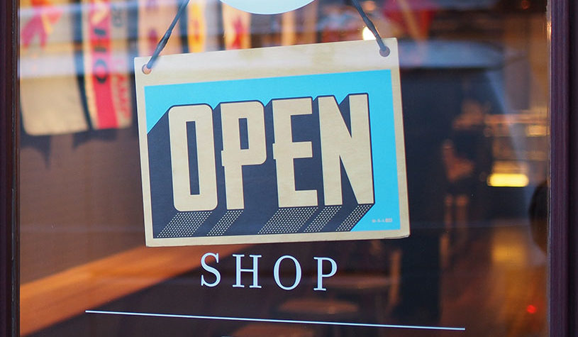 open sign in a door for a shop