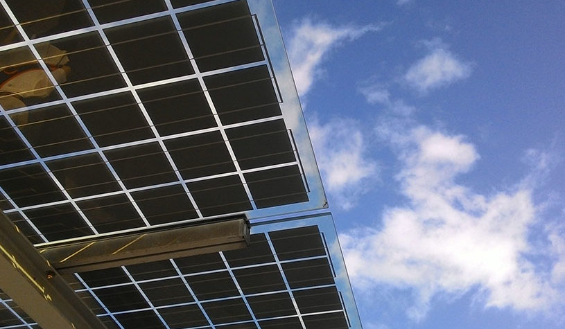 Low angle shot of solar panels and the sky during the day