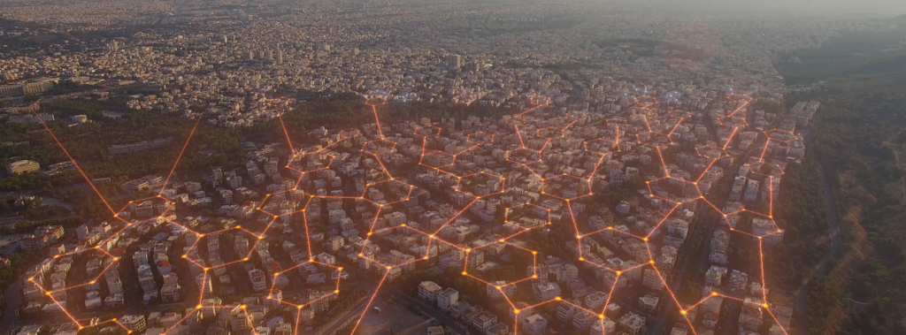 A city scape illuminated by an orange hexagonal grid.