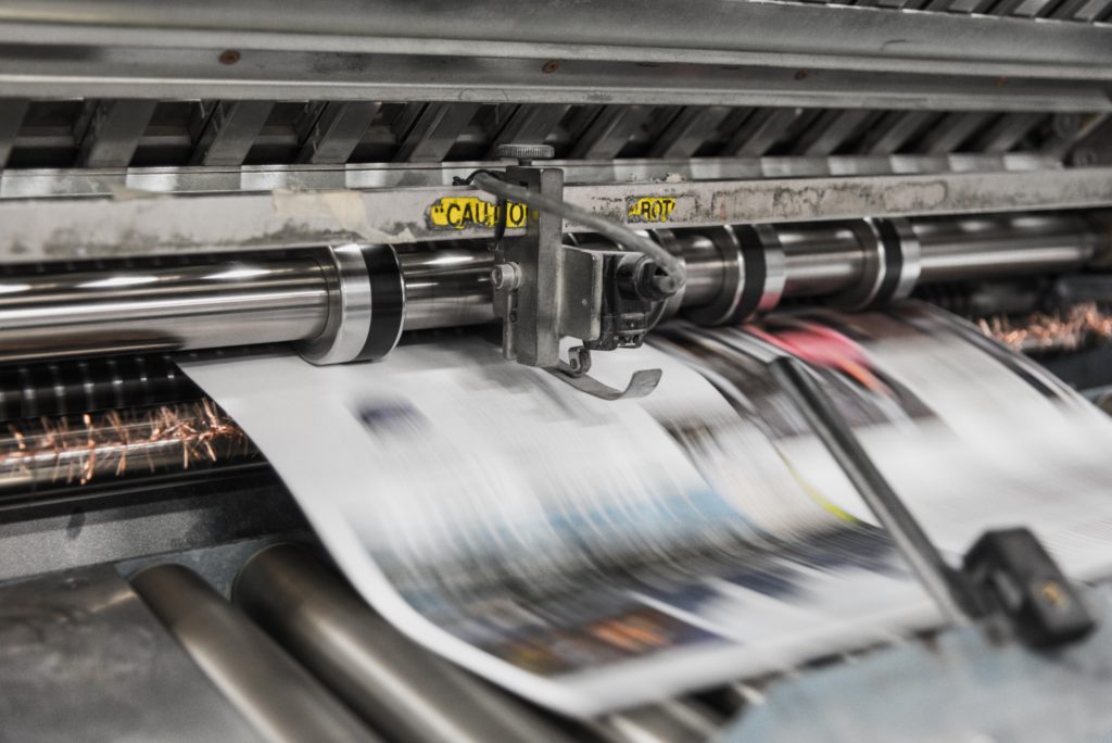 A commercial printer printing a newspaper.
