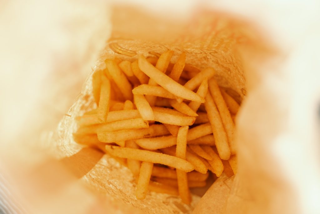A birds eye view of bag of golden french fries.