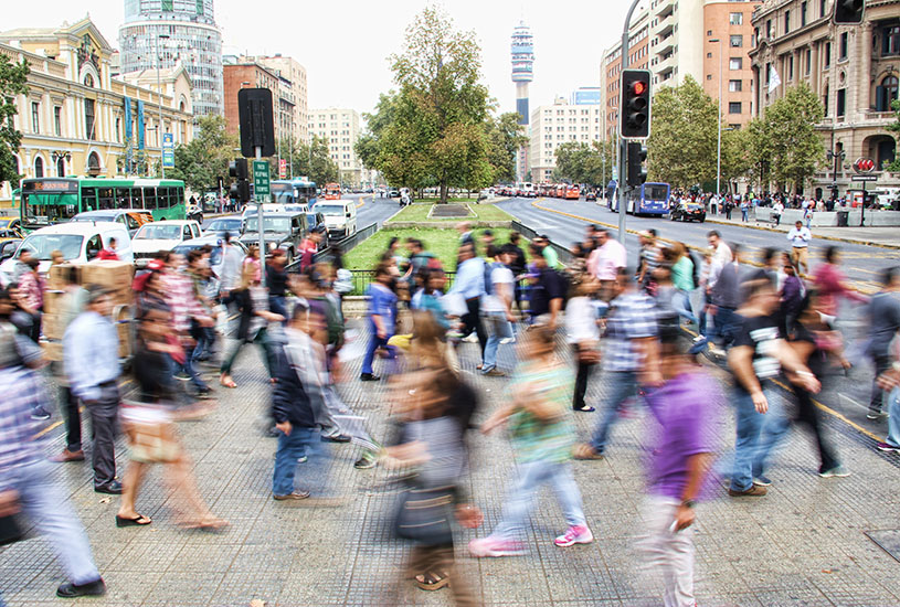 A group of people walking across the street.