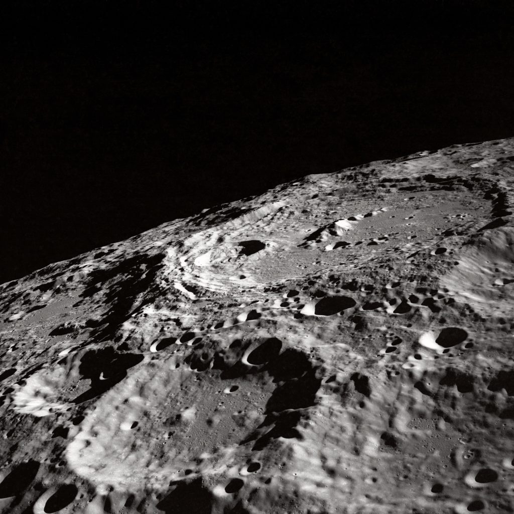 A close up on the surface of the moon, with craters in focus.