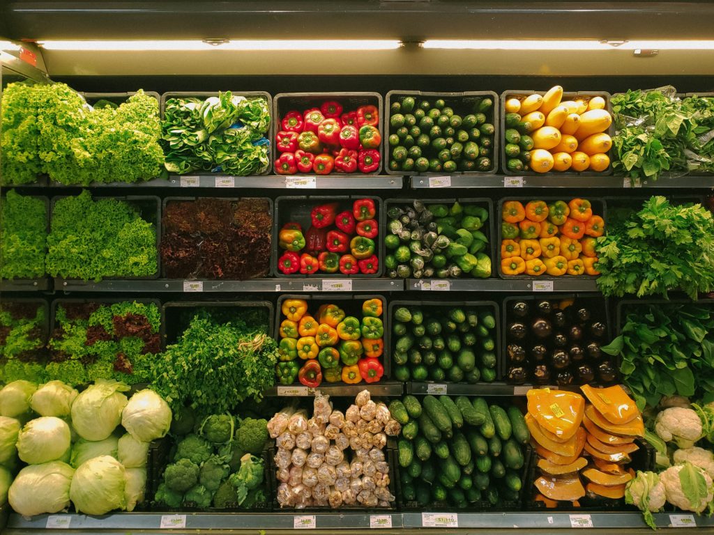 Rows of fruit and vegetables in a supermarket.