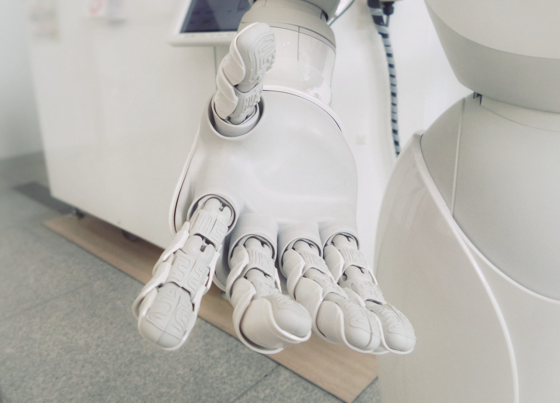 A robot extending its hand to the viewer.
