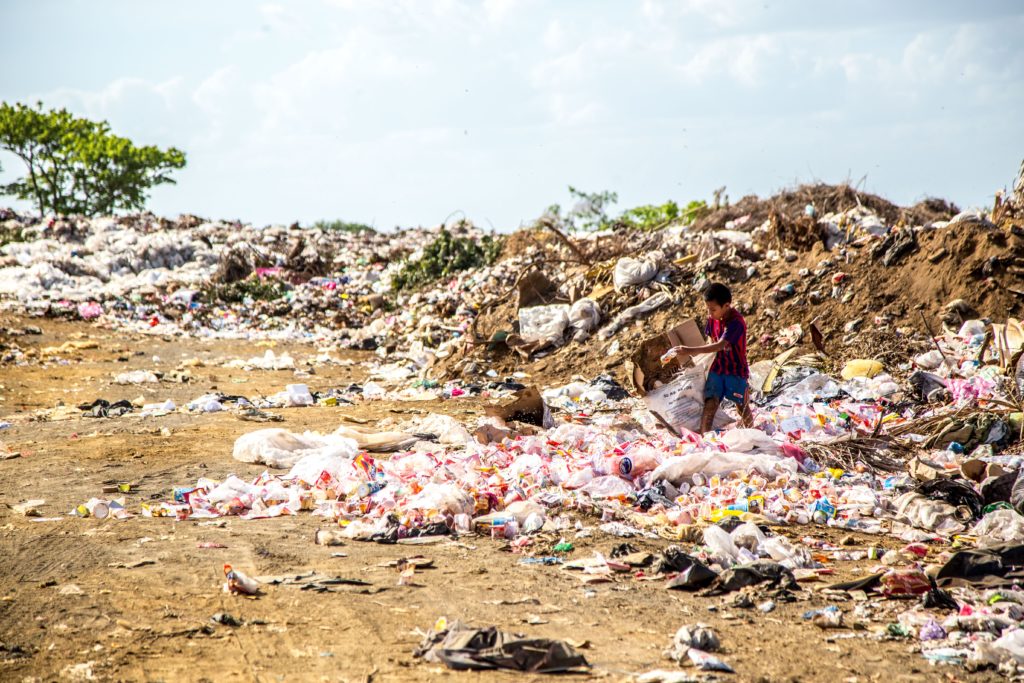 A young boy trawling through trash in Nicaragua.