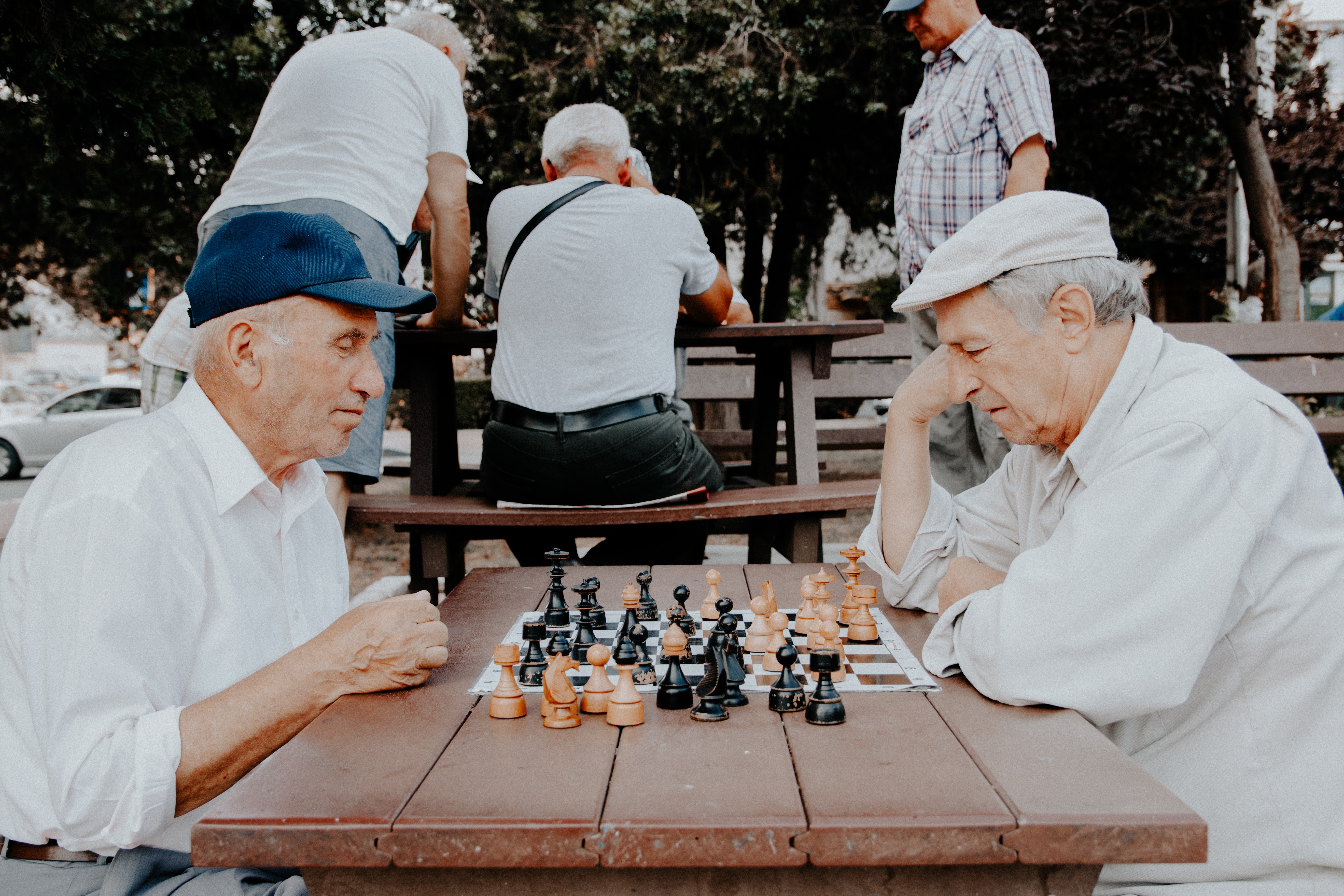 Two elderly man playing chess in the local park.