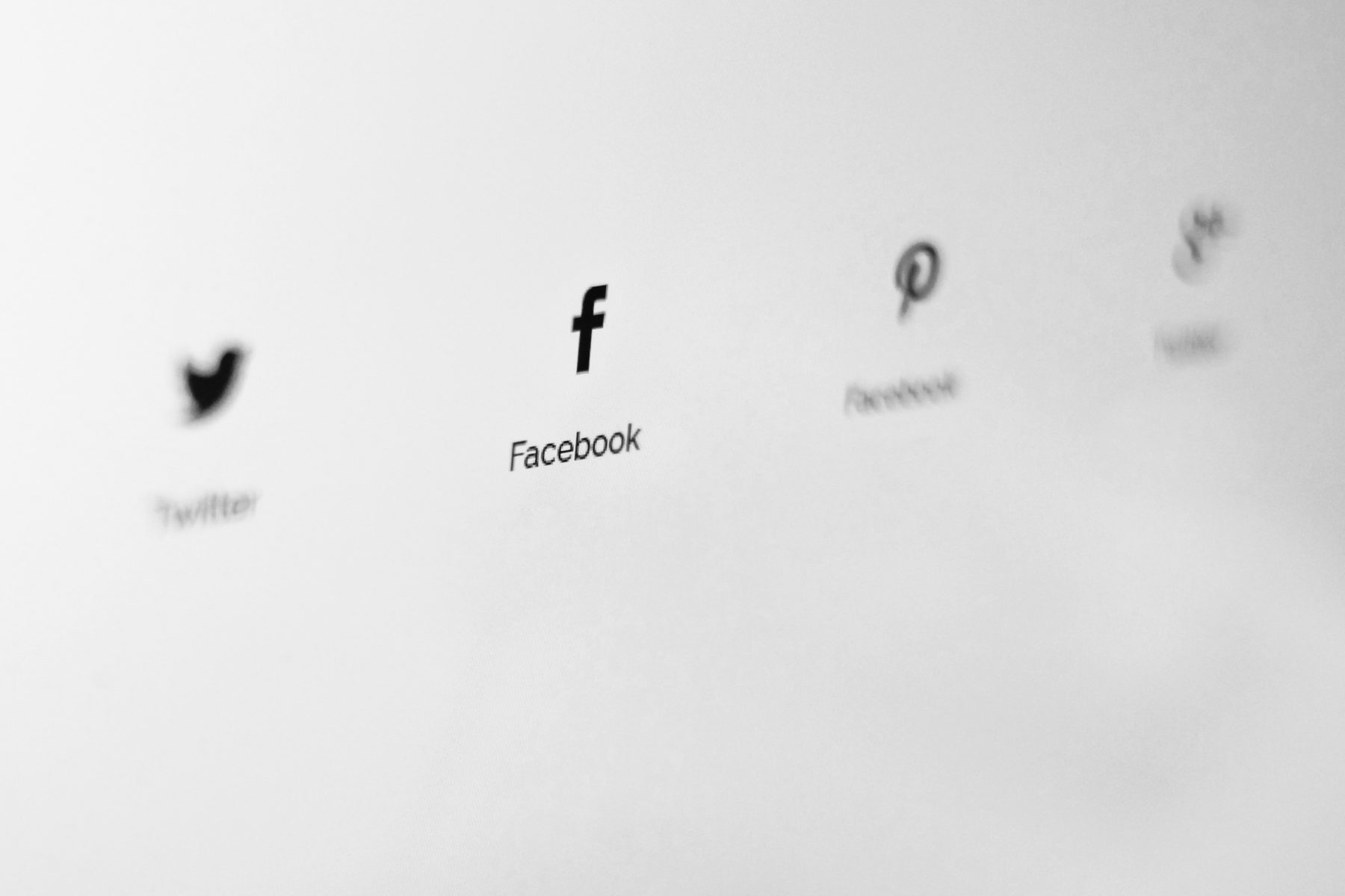 The Twitter, Facebook, Pinterest and Tik Tok icons, with the Facebook symbol the most in focus.