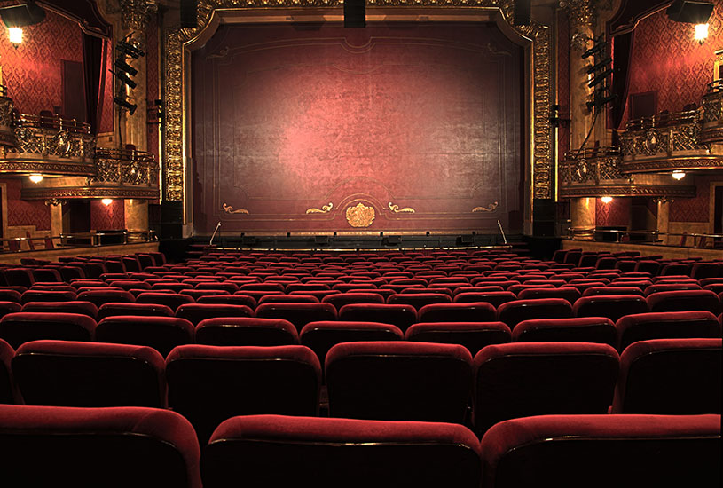 Red velvet seats in a cinema.