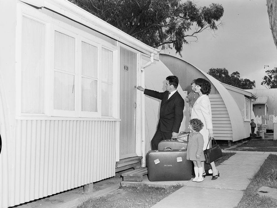 An Italian migrant family entering a hut at the Brooklyn Migrant Hotel in Melbourne.