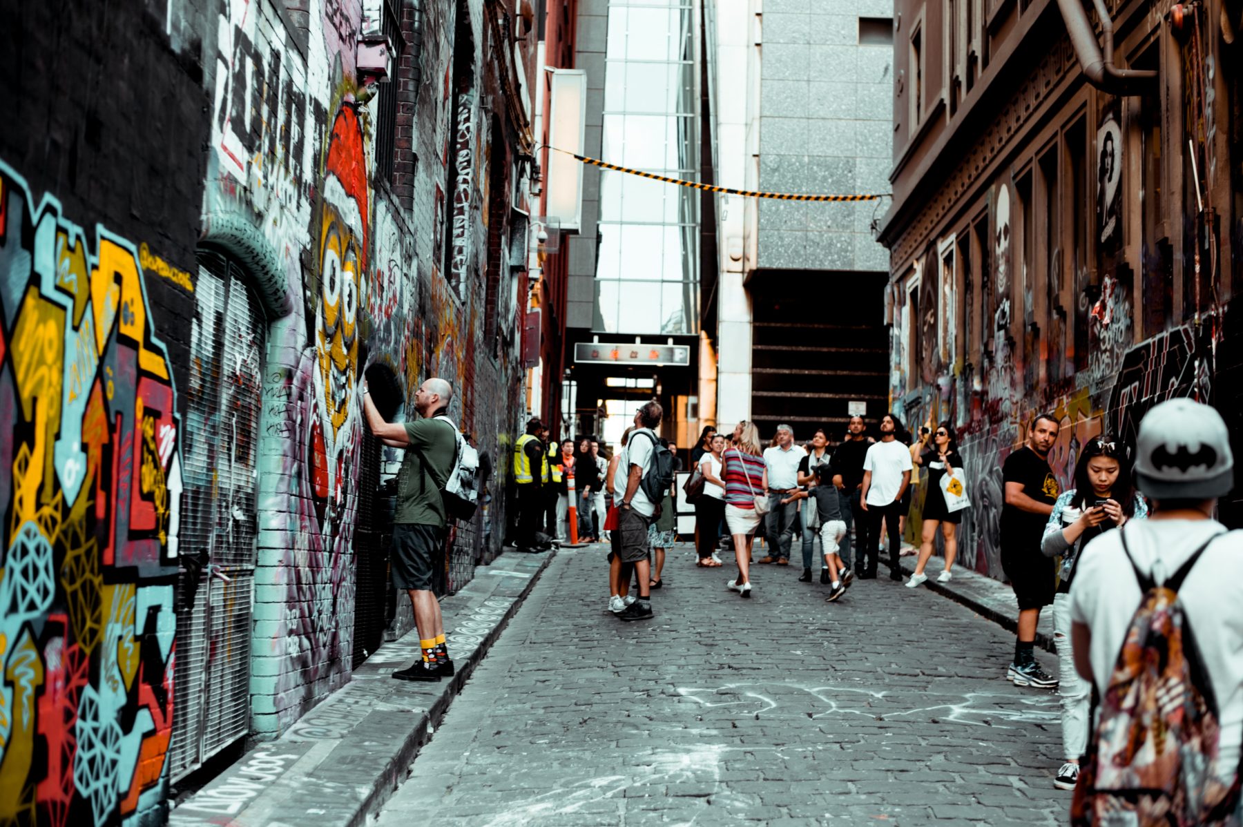 Tourists looking at street art in Melbourne, Australia.