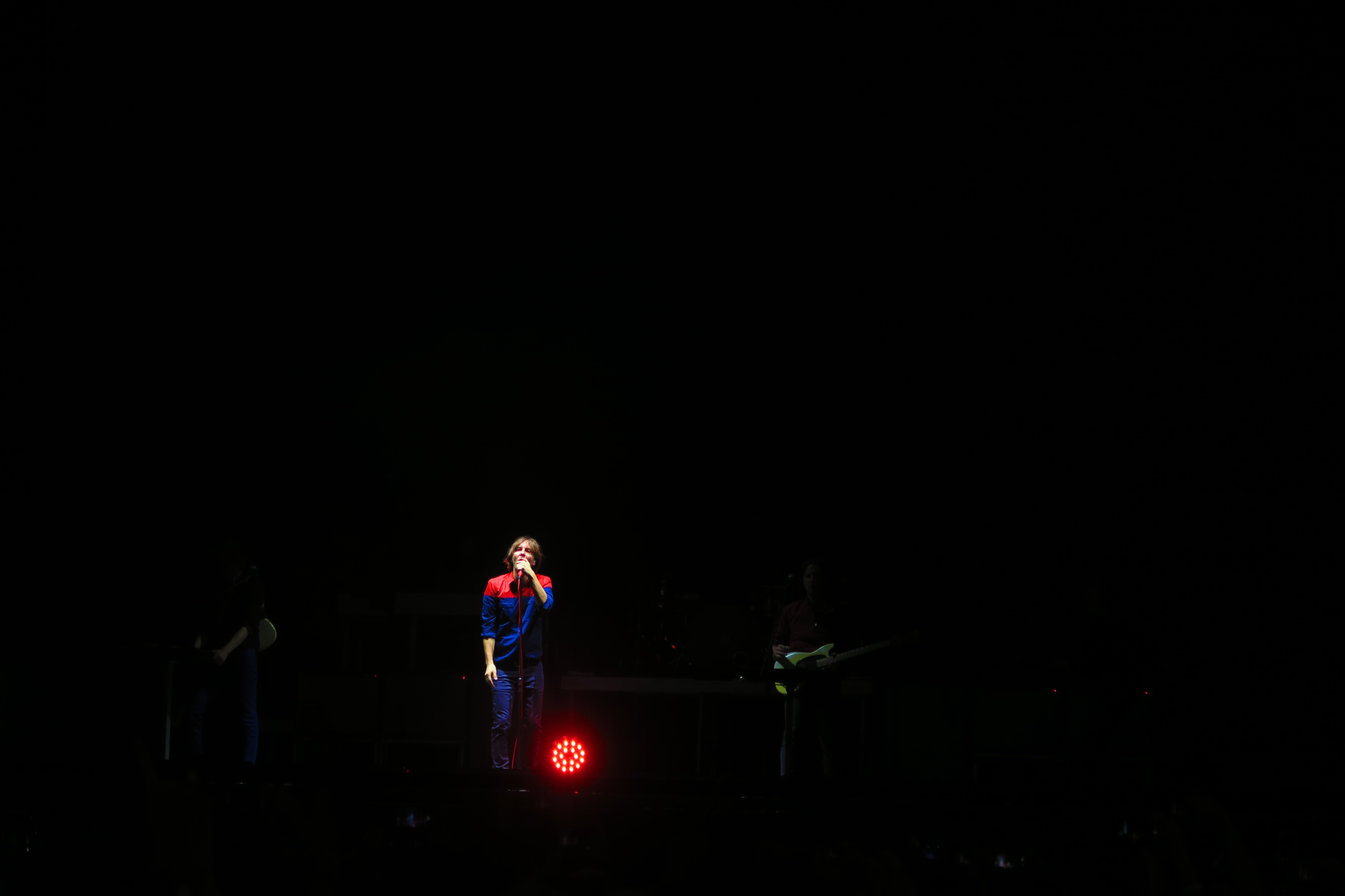 A lone woman performing solo on stage.