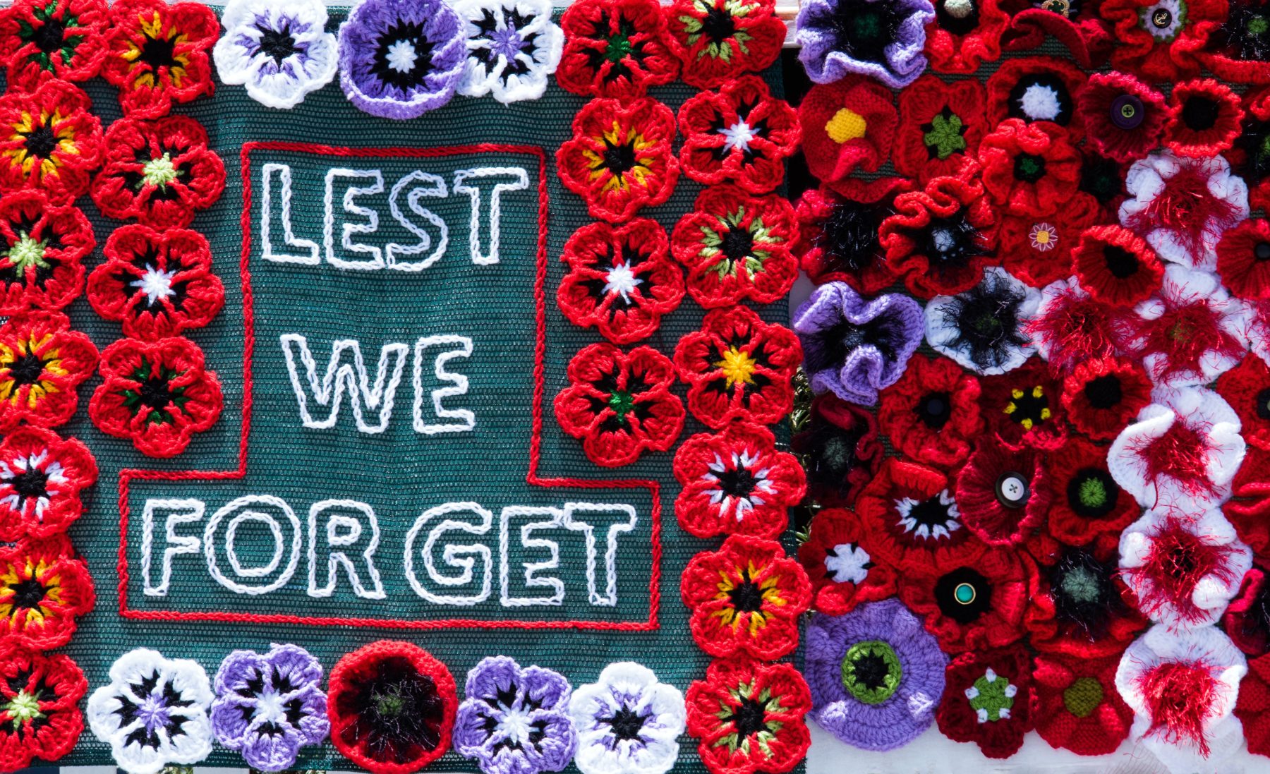 An ANZAC memorial with the words "lest we forget" embroidered on it.