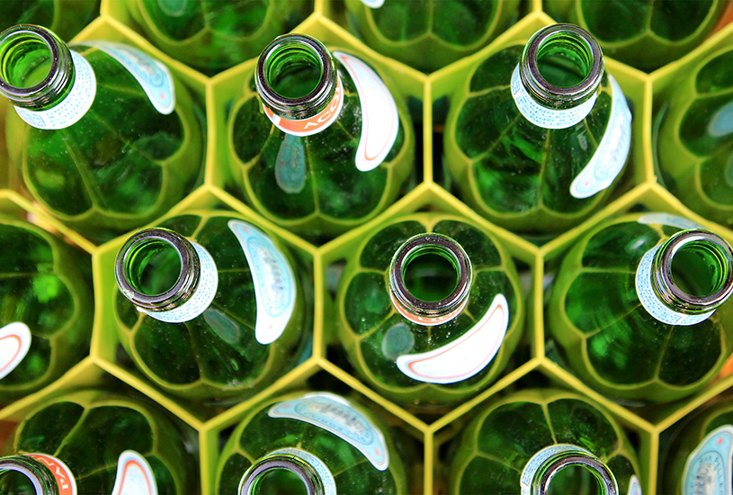 Glass bottles lined up next to each other.