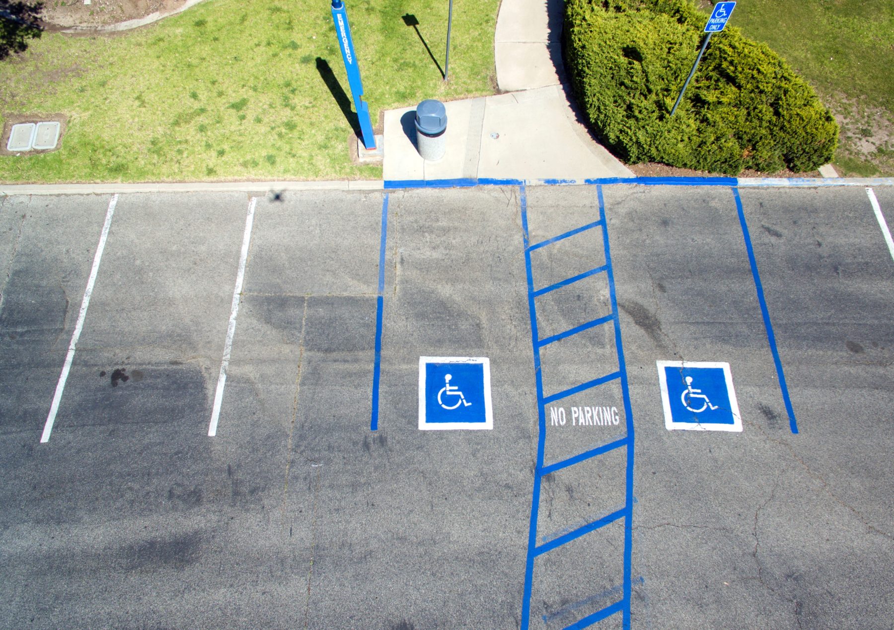 A car park with the disabled parking spots clearly outlined in blue paint.