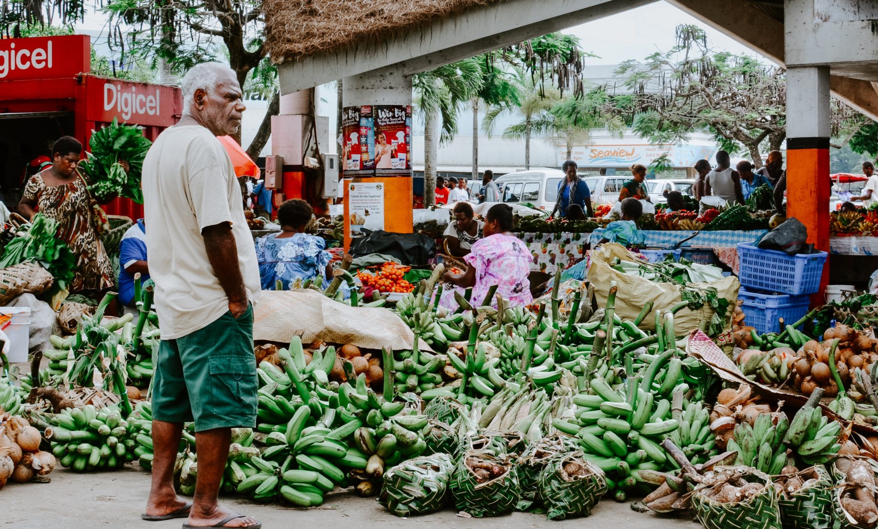 An elderly man standing in a market in Vanuatu.
