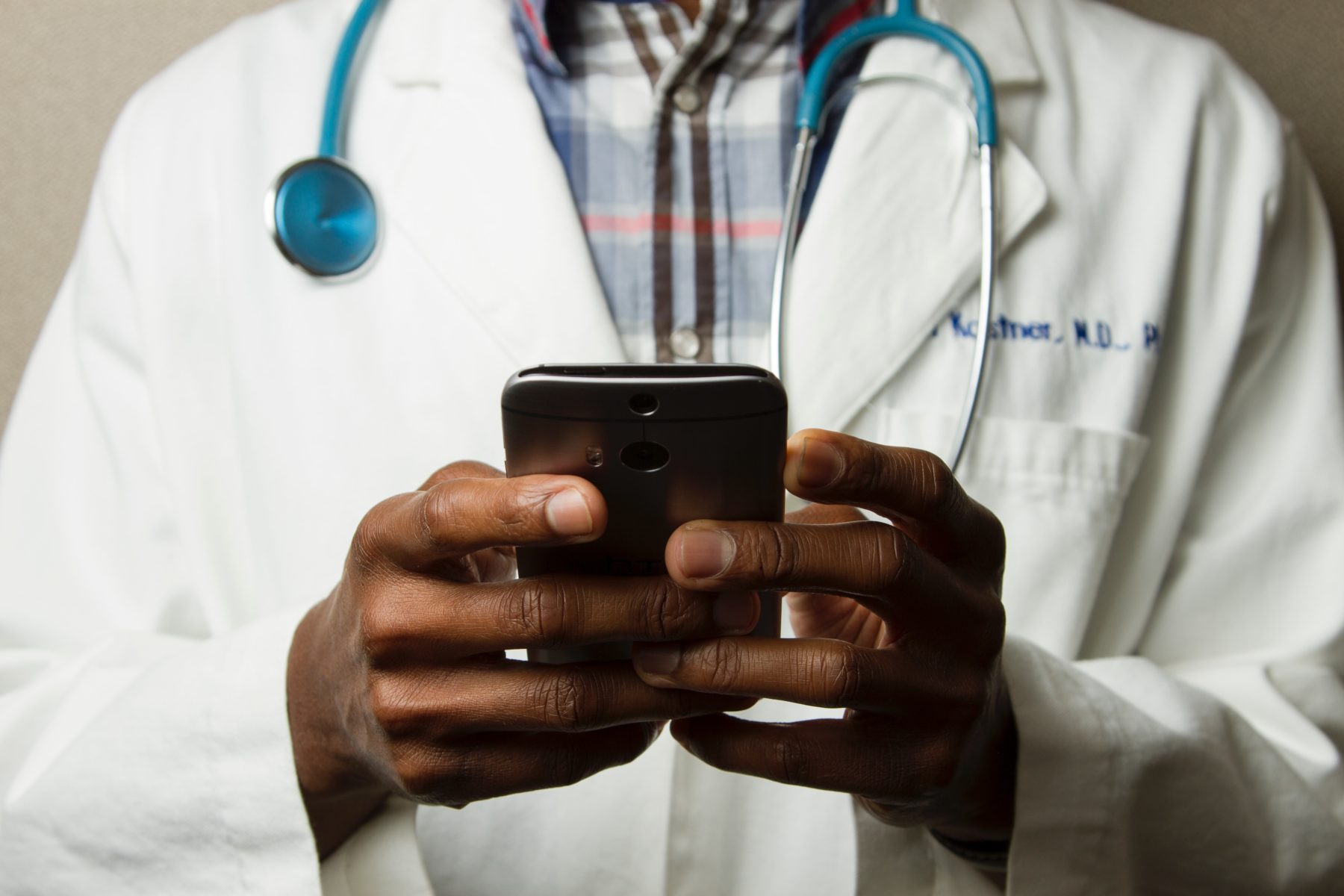 A doctor holding a mobile phone.