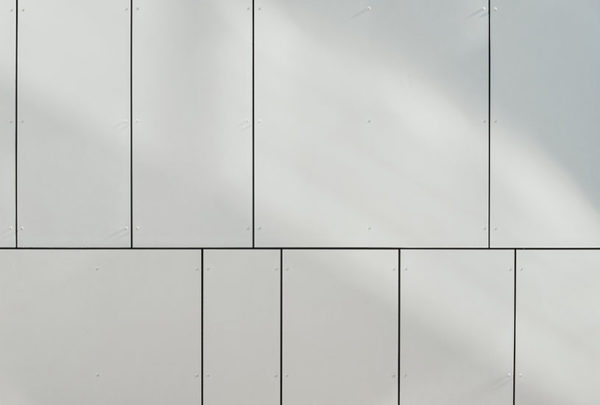 A wall with multiple, different sized, white panels.