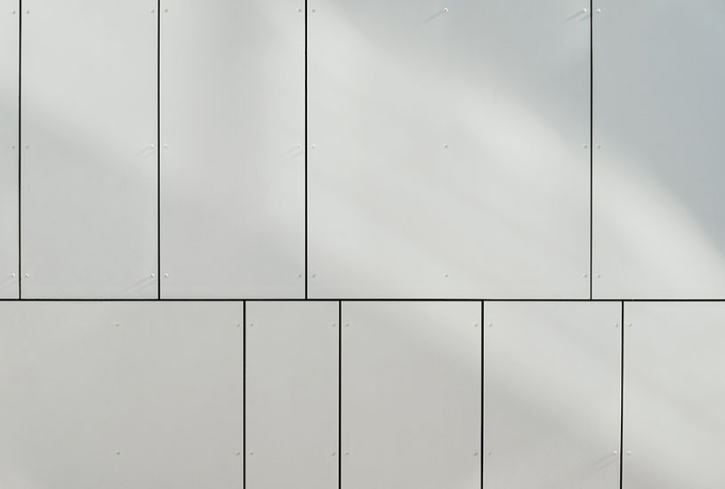 A wall with multiple, different sized, white panels.