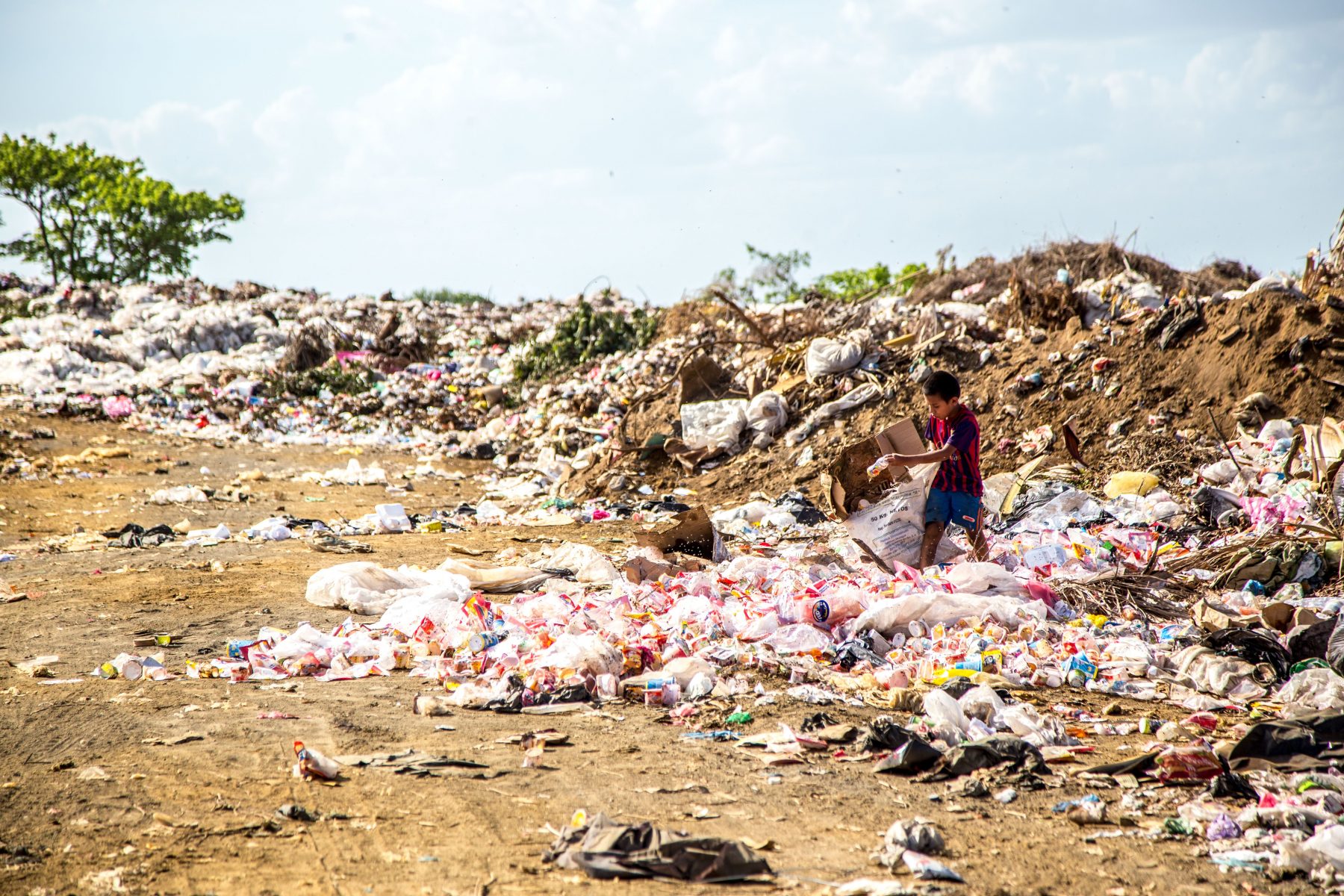 A young boy picking through rubbish at a tip in Nicaragua.