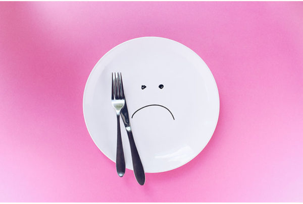 Image of plate with a sad face drawn on it