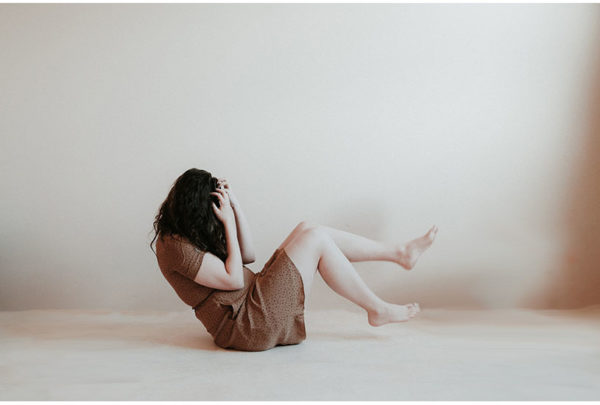 Image of woman clutching her hair in distress