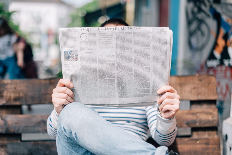 Image of a person reading a newspaper