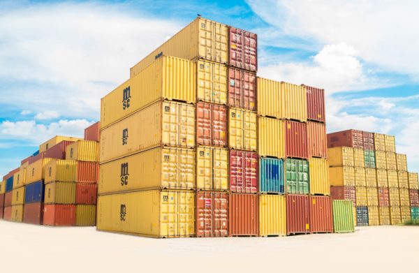 Image of a series of yellow, red, blue and green shipping containers stacked on top of each other